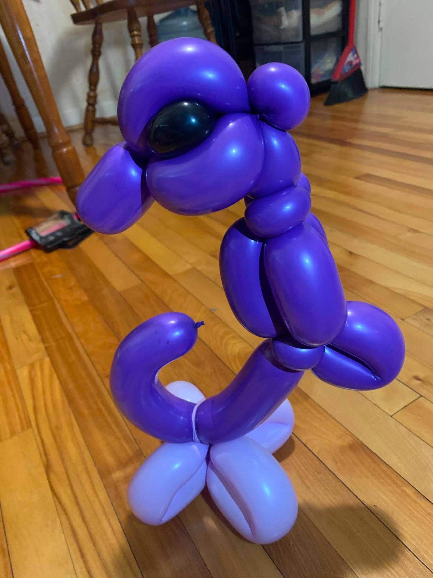 Purple balloon character with big eyes