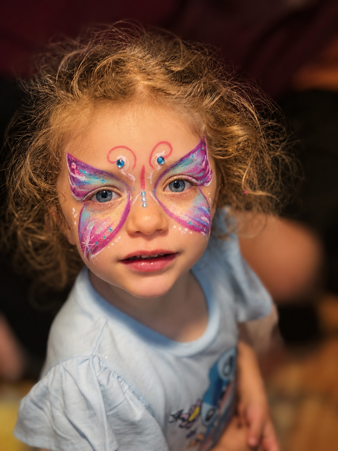 Butterfly face painting on a young girl